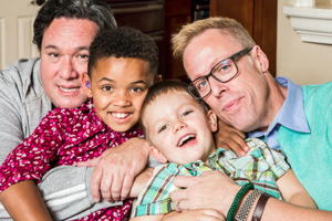 Two men sat with two children Two men sat with two children