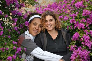 Two females surrounded by purple flowers Two females surrounded by purple flowers